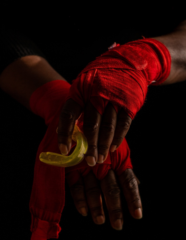 A boxer holding a mouthguard