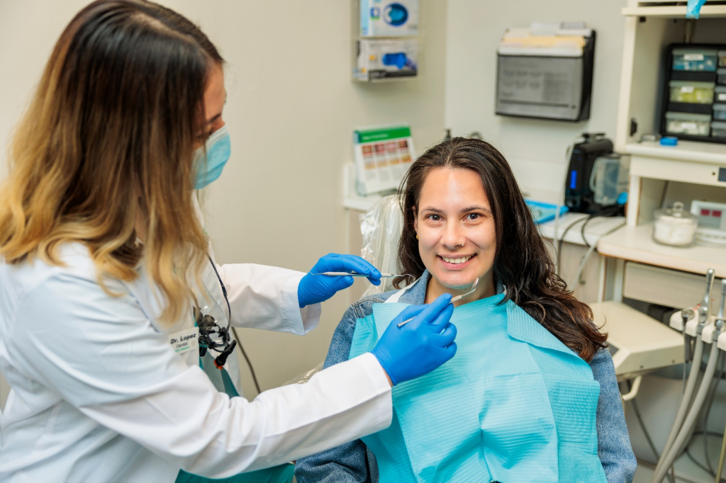 A stress-free patient sitting on the dental chair while her dentist performs a dental exam